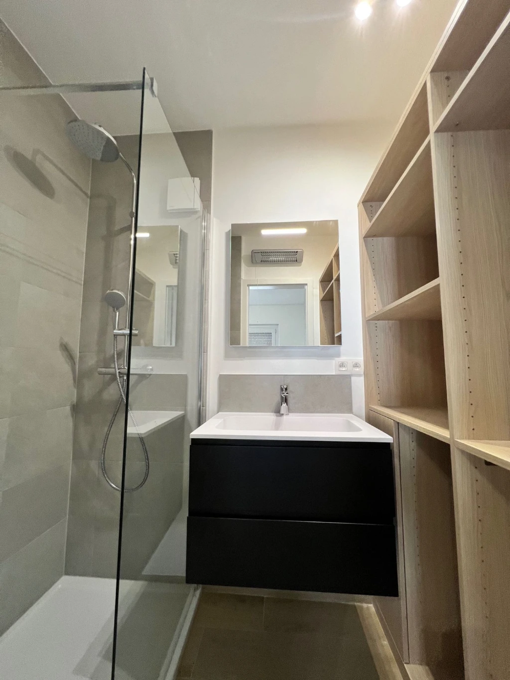 Salle de douche avec meuble-vasque et rangements dans l’appartement du 5e étage à Liège centre